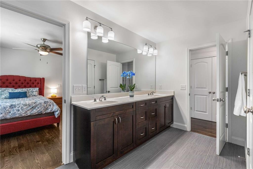 2456 Sunset Drive Northeast Atlanta, GA 30345 - Photo 33 of 49 a spacious bathroom with a double vanity sink and a mirror
