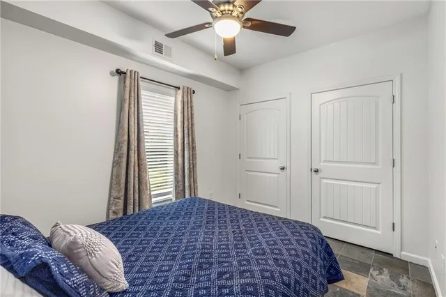 a bedroom with a bed and a window