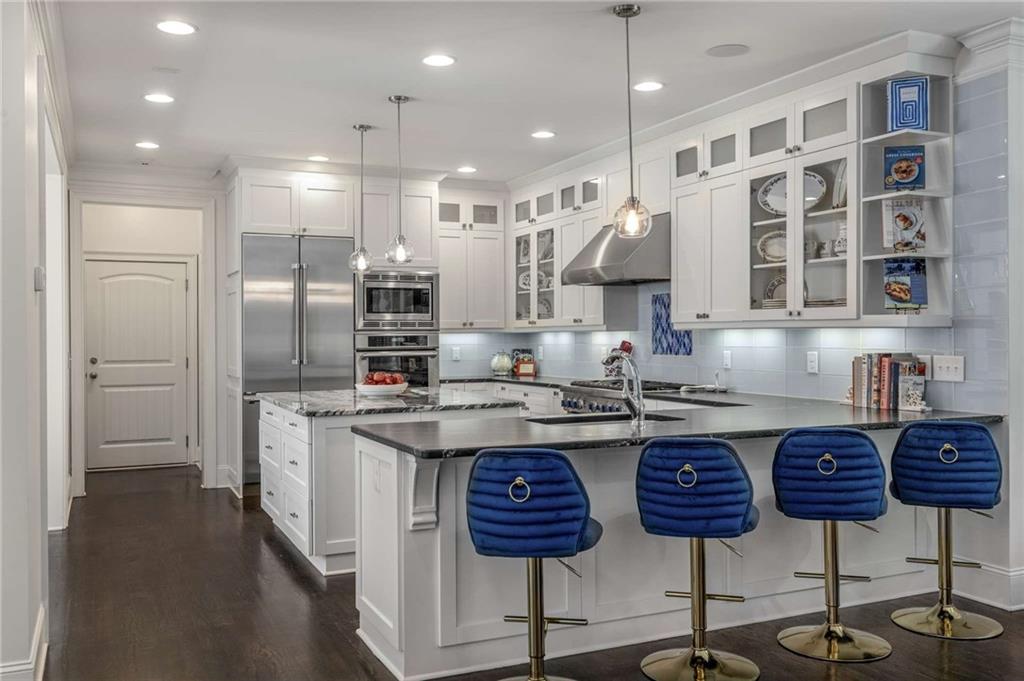 2456 Sunset Drive Northeast Atlanta, GA 30345 - Photo 4 of 49 a kitchen with cabinets and chairs
