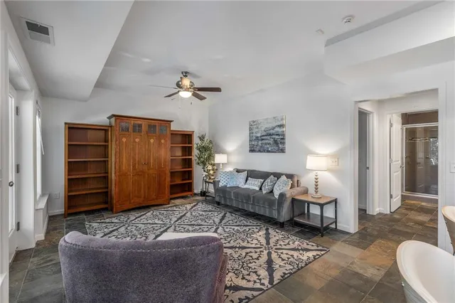 a living room with furniture ceiling fan and a rug
