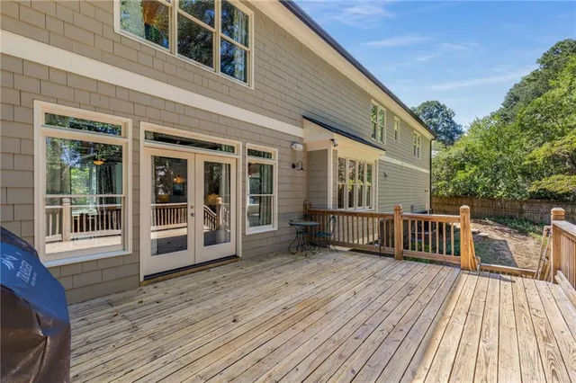 a view of a house with wooden deck