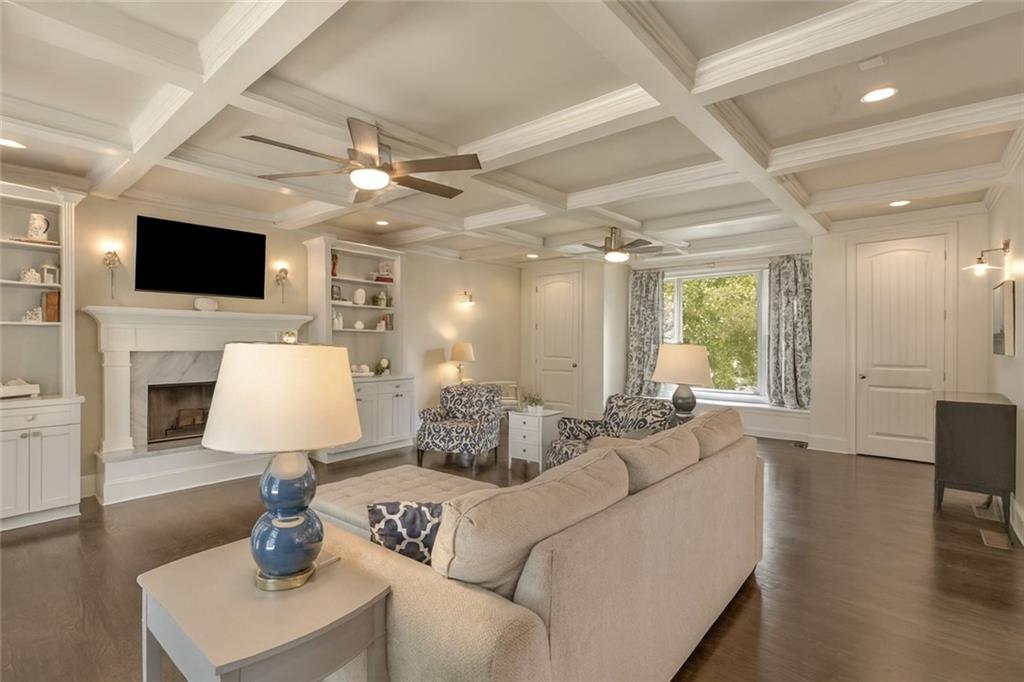2456 Sunset Drive Northeast Atlanta, GA 30345 - Photo 6 of 49 a living room with furniture a fireplace and a flat screen tv