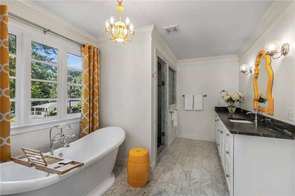 2456 Sunset Drive Northeast Atlanta, GA 30345 - Photo 8 of 49 a bathroom with a tub sink and mirror