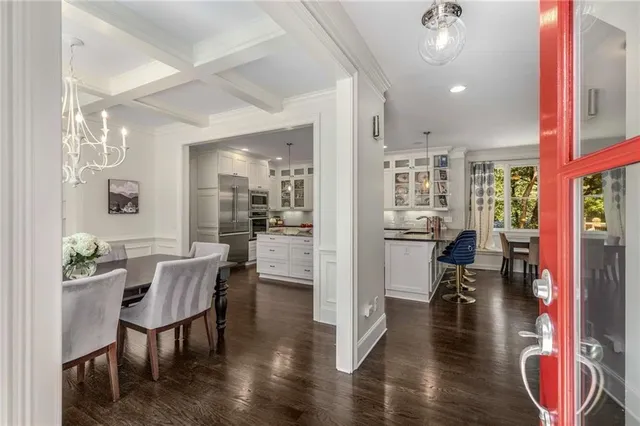 a dining room with furniture and wooden floor