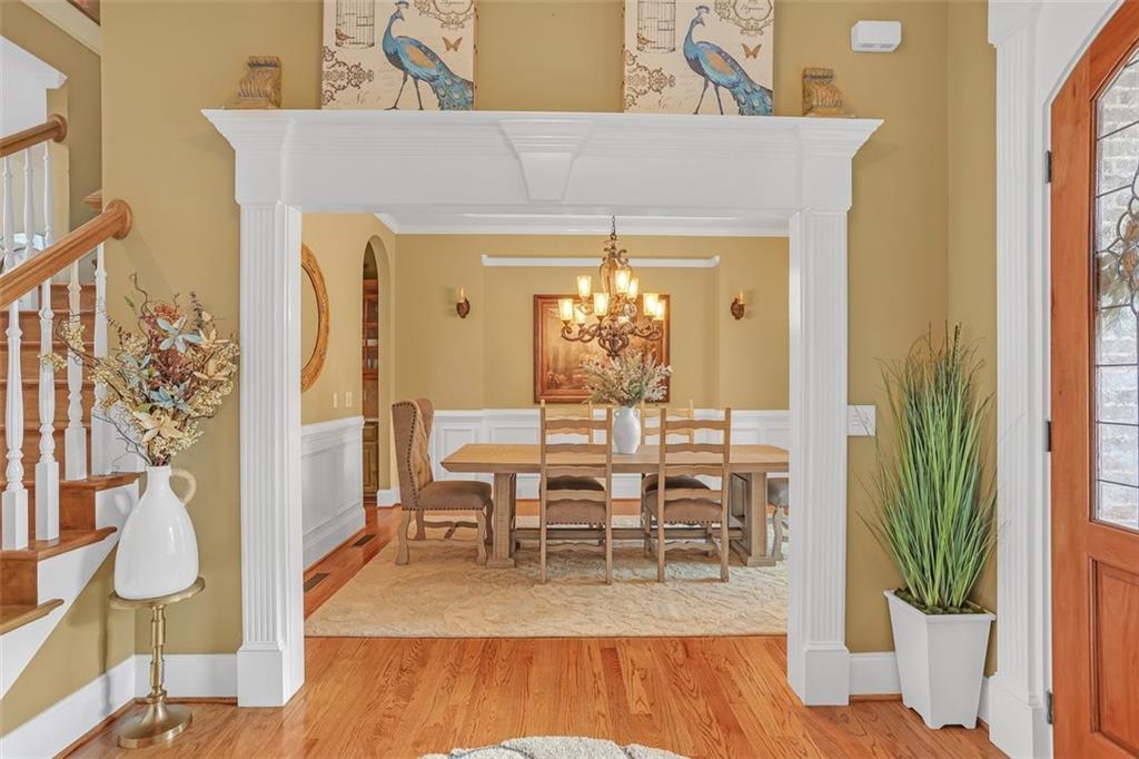 1385 Harris Road Lawrenceville, GA 30043 - Photo 11 of 76 a view of a dining room with furniture a chandelier and wooden floor