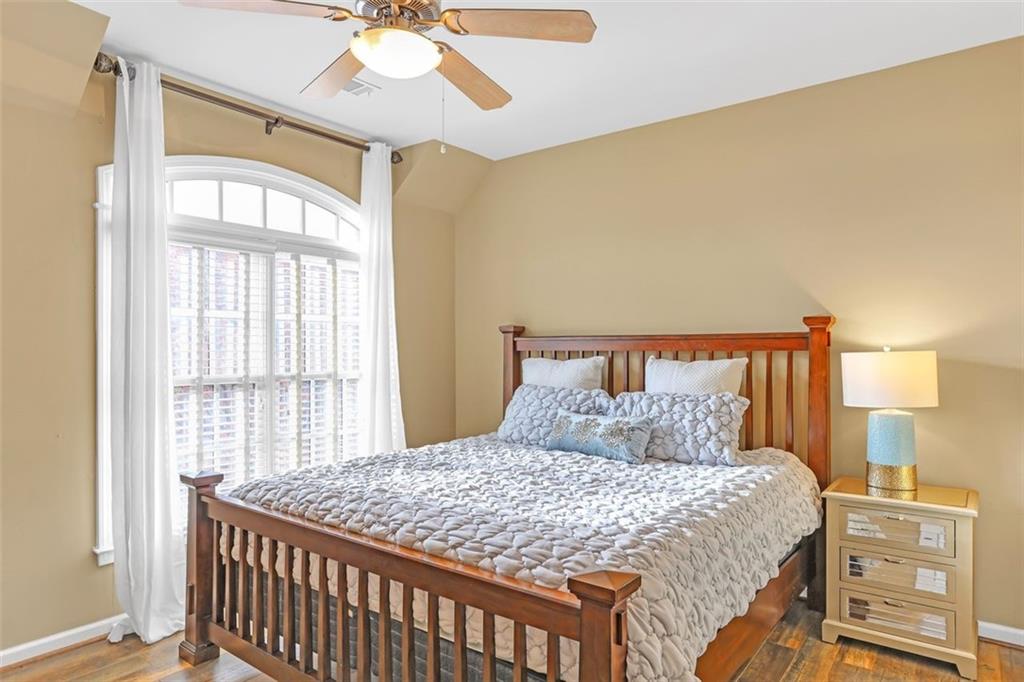 1385 Harris Road Lawrenceville, GA 30043 - Photo 33 of 76 a bedroom with a large bed and a chandelier