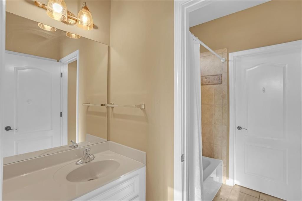 1385 Harris Road Lawrenceville, GA 30043 - Photo 34 of 76 a bathroom with a sink and a mirror