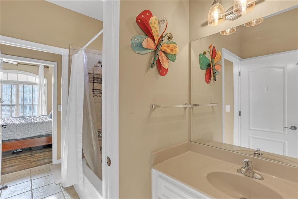 1385 Harris Road Lawrenceville, GA 30043 - Photo 36 of 76 a bathroom with a granite countertop sink and a mirror