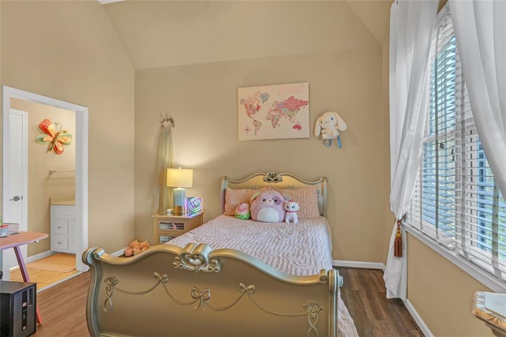 1385 Harris Road Lawrenceville, GA 30043 - Photo 38 of 76 a bedroom with a bed and wooden floor