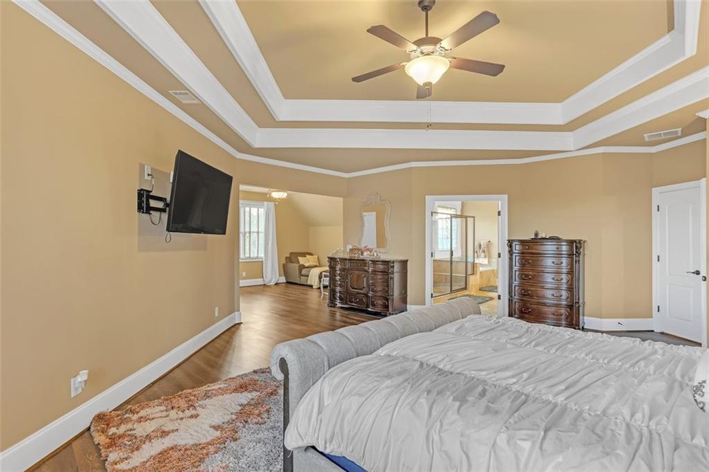 1385 Harris Road Lawrenceville, GA 30043 - Photo 45 of 76 a spacious bedroom with a bed and a flat screen tv