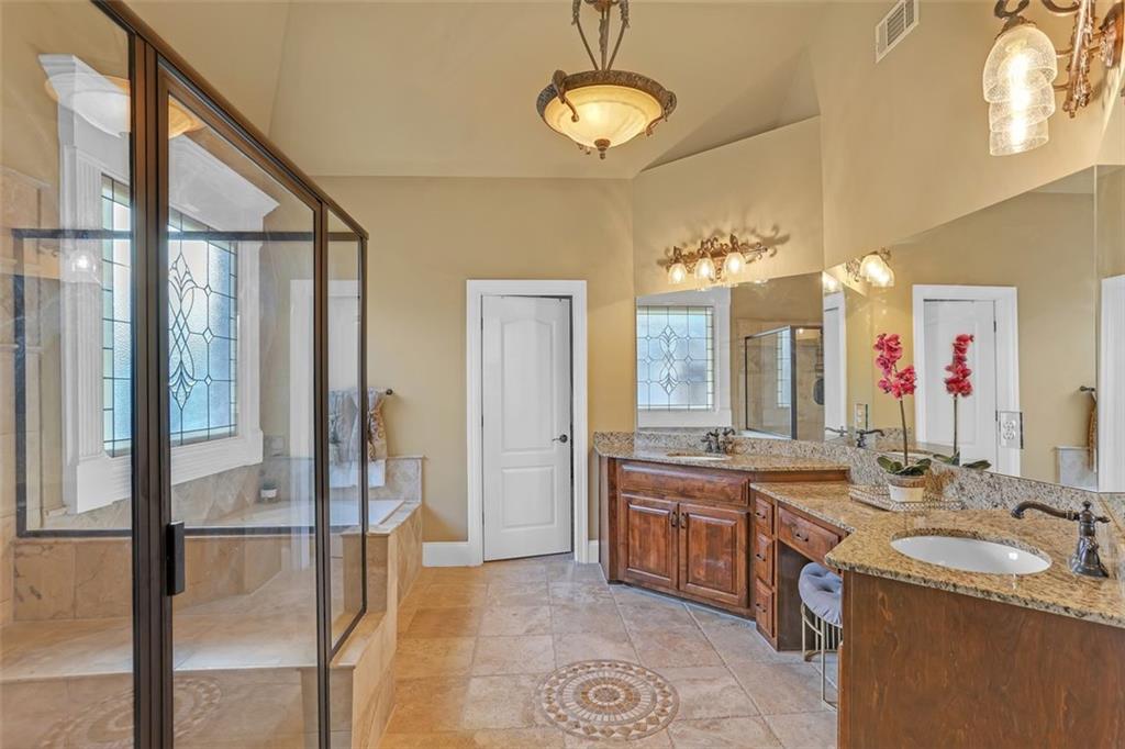 1385 Harris Road Lawrenceville, GA 30043 - Photo 46 of 76 a spacious bathroom with a double vanity sink a mirror and a shower
