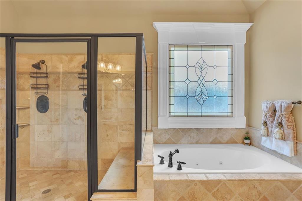 1385 Harris Road Lawrenceville, GA 30043 - Photo 47 of 76 a bathroom with a bathtub and a shower