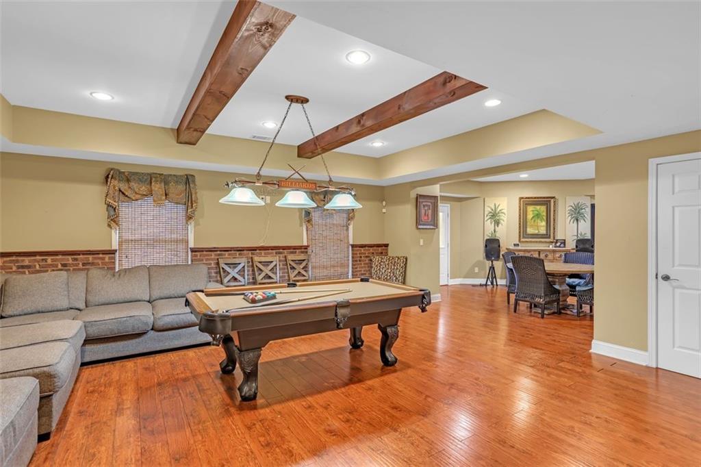 1385 Harris Road Lawrenceville, GA 30043 - Photo 51 of 76 a living room with furniture a wooden floor and a large window