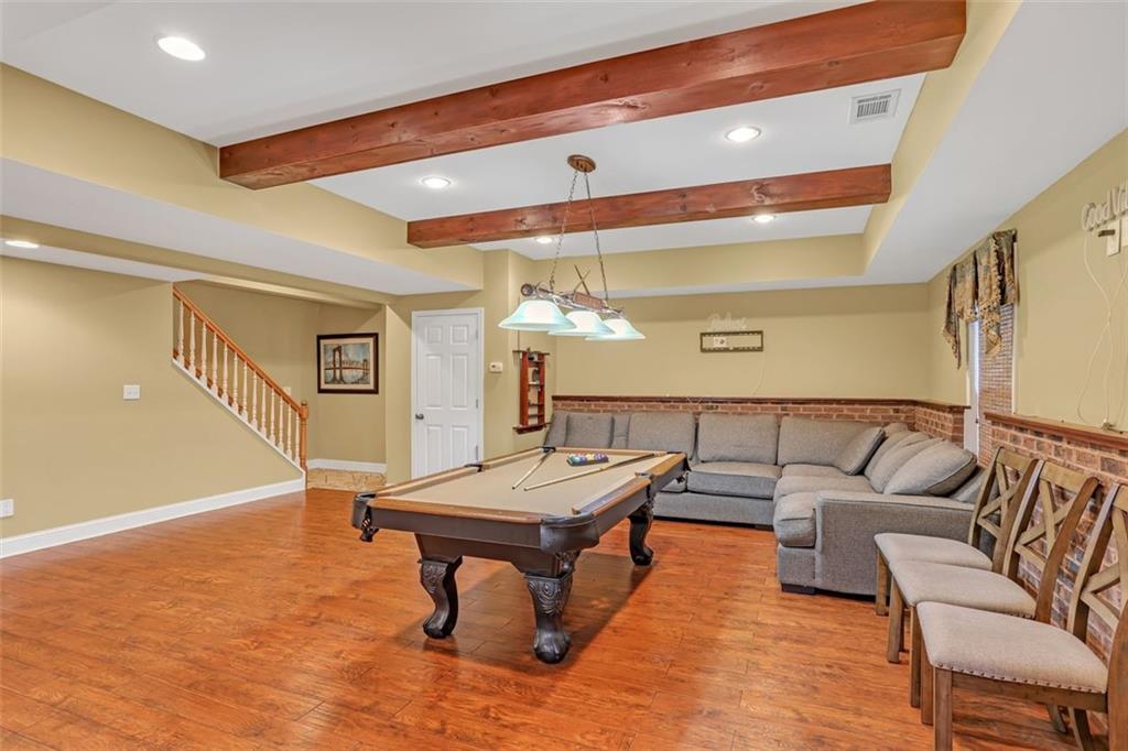 1385 Harris Road Lawrenceville, GA 30043 - Photo 52 of 76 a living room with furniture and a wooden floor