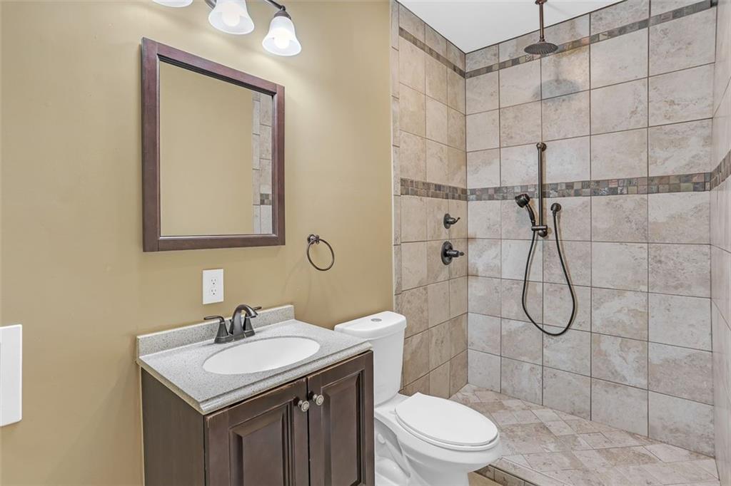 1385 Harris Road Lawrenceville, GA 30043 - Photo 55 of 76 a bathroom with a sink toilet and shower