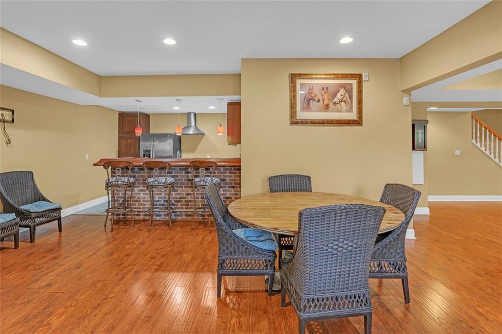 1385 Harris Road Lawrenceville, GA 30043 - Photo 57 of 76 a dining room with furniture and wooden floor