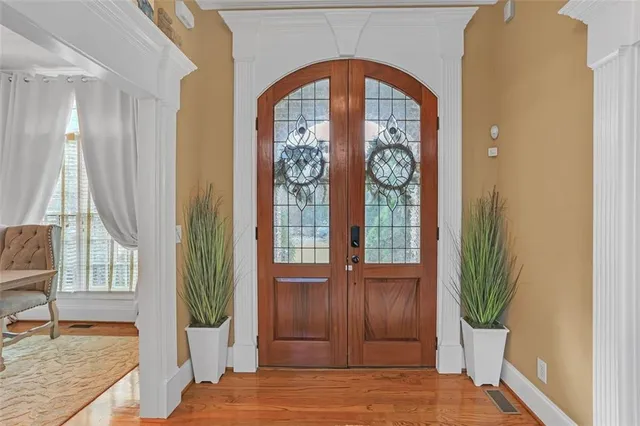 a living room with furniture a table and wooden floor