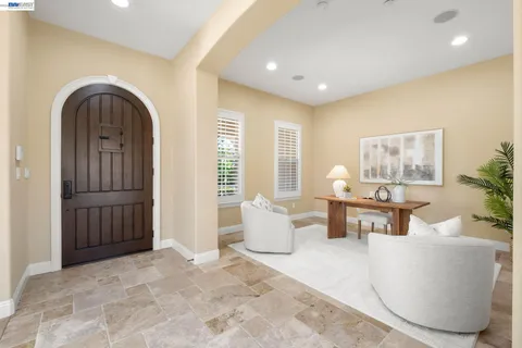 a living room with furniture and a potted plant
