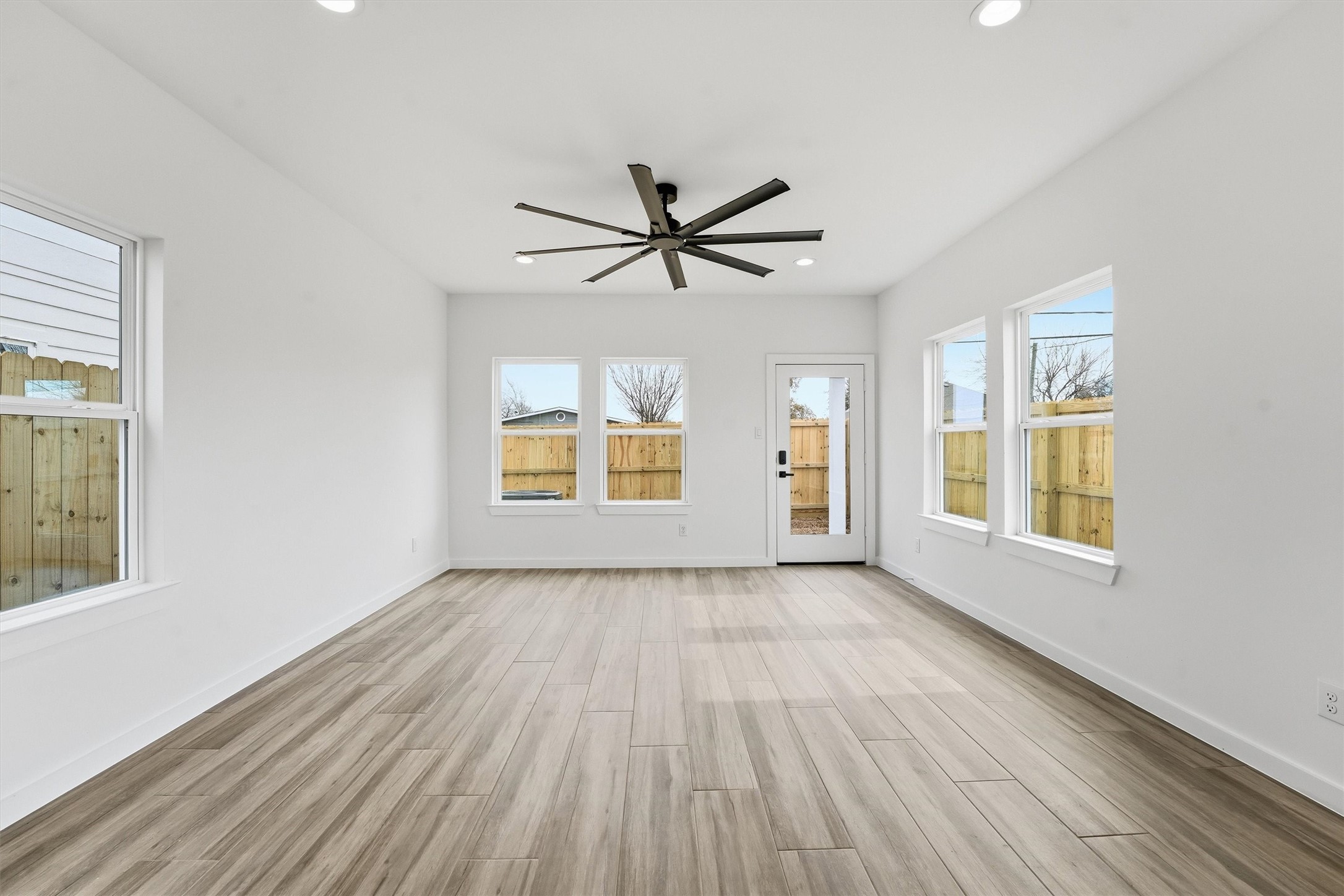 524 North 4th Street La Porte, TX 77571 - Photo 15 of 25 an empty room with chandelier fan and windows