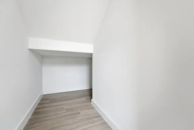 a view of hallway with wooden floor