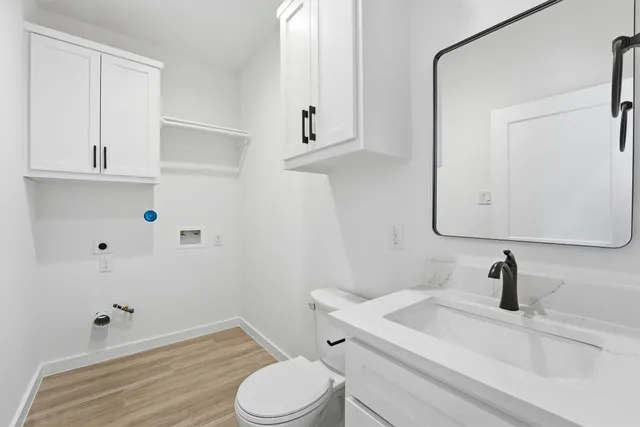 a bathroom with a sink a toilet and mirror