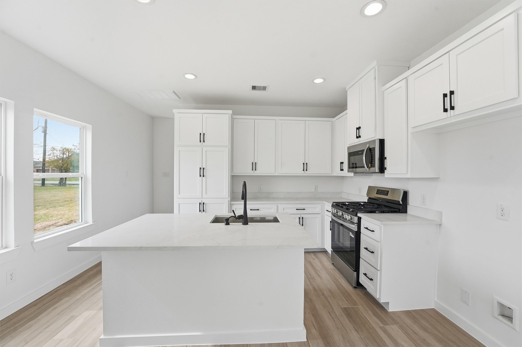524 North 4th Street La Porte, TX 77571 - Photo 10 of 25 a kitchen with stainless steel appliances granite countertop a sink a stove and a refrigerator