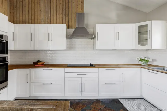 a kitchen with white cabinets and white appliances