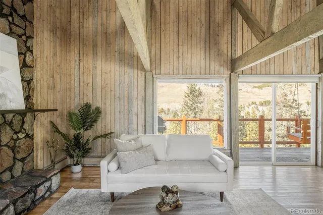 a living room with furniture and a floor to ceiling window
