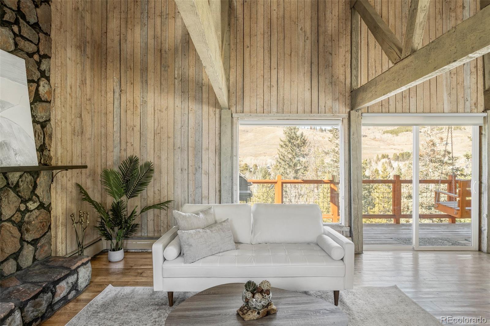297 Deer Path Road Dillon, CO 80435 - Photo 15 of 49 a living room with furniture and a floor to ceiling window