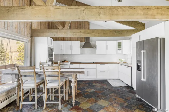 a kitchen with stainless steel appliances a refrigerator and cabinets