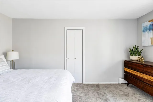 a bedroom with a bed and a potted plant