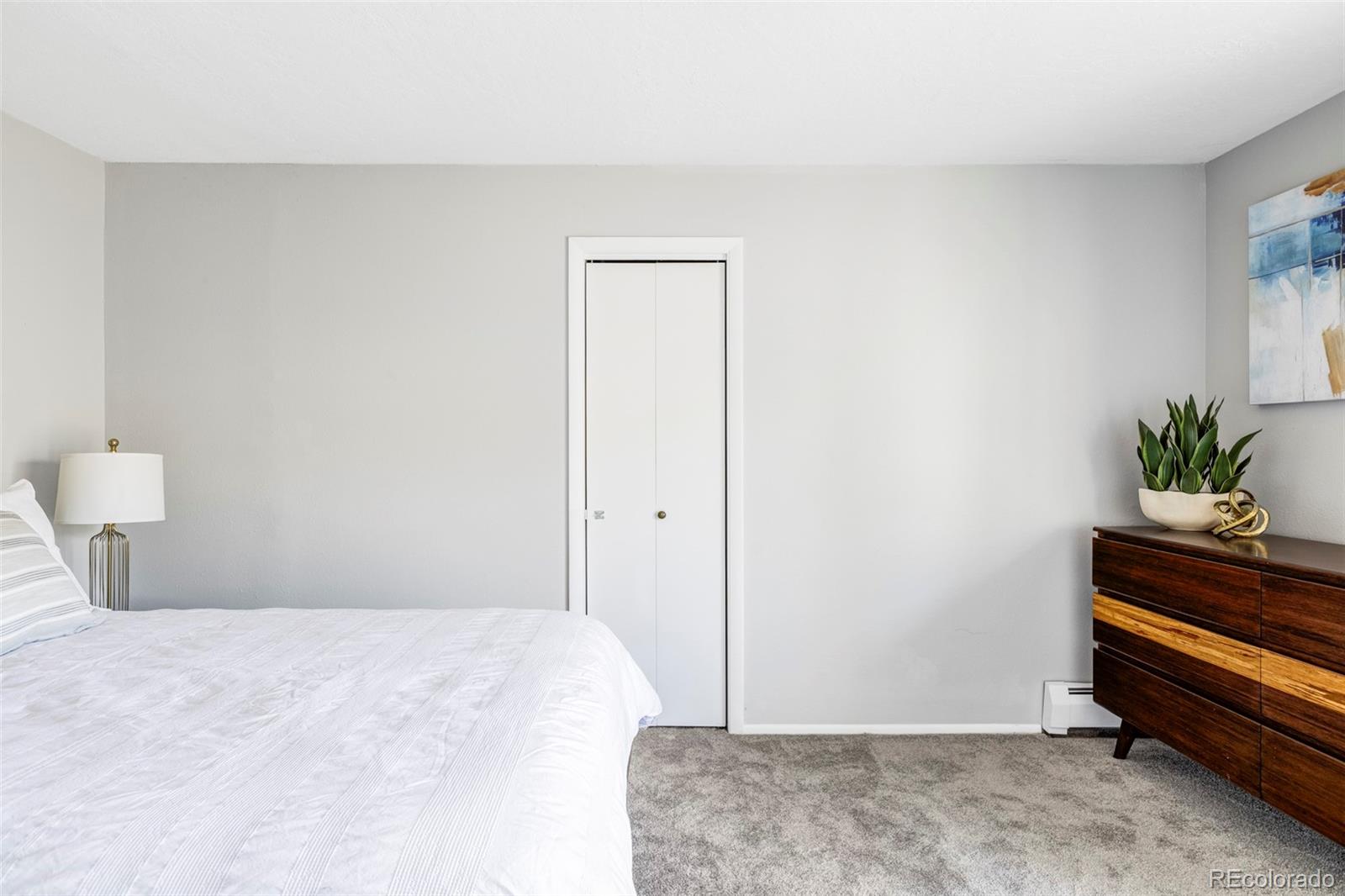 297 Deer Path Road Dillon, CO 80435 - Photo 24 of 49 a bedroom with a bed and a potted plant