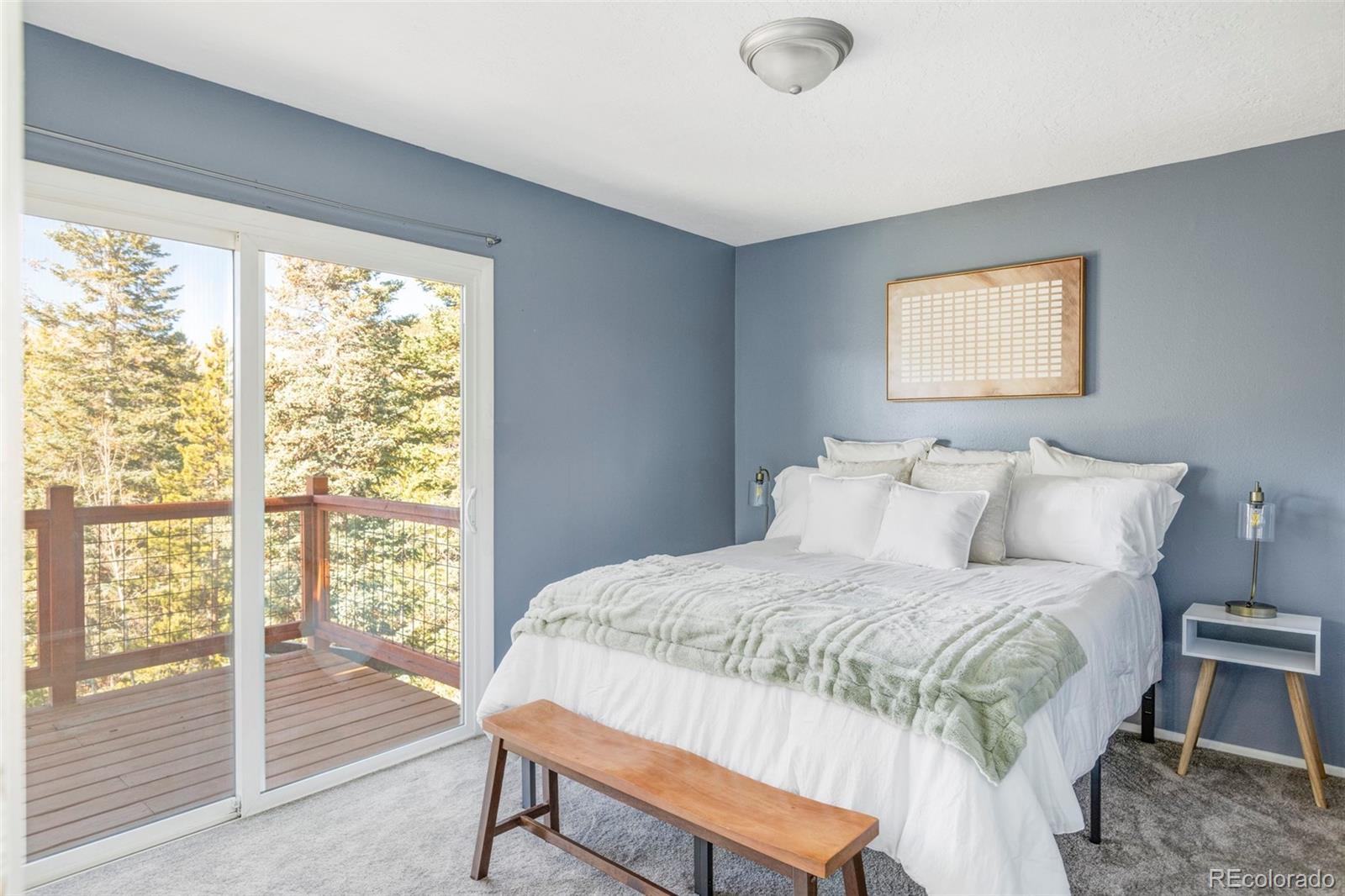 297 Deer Path Road Dillon, CO 80435 - Photo 26 of 49 a bedroom with a bed and a window