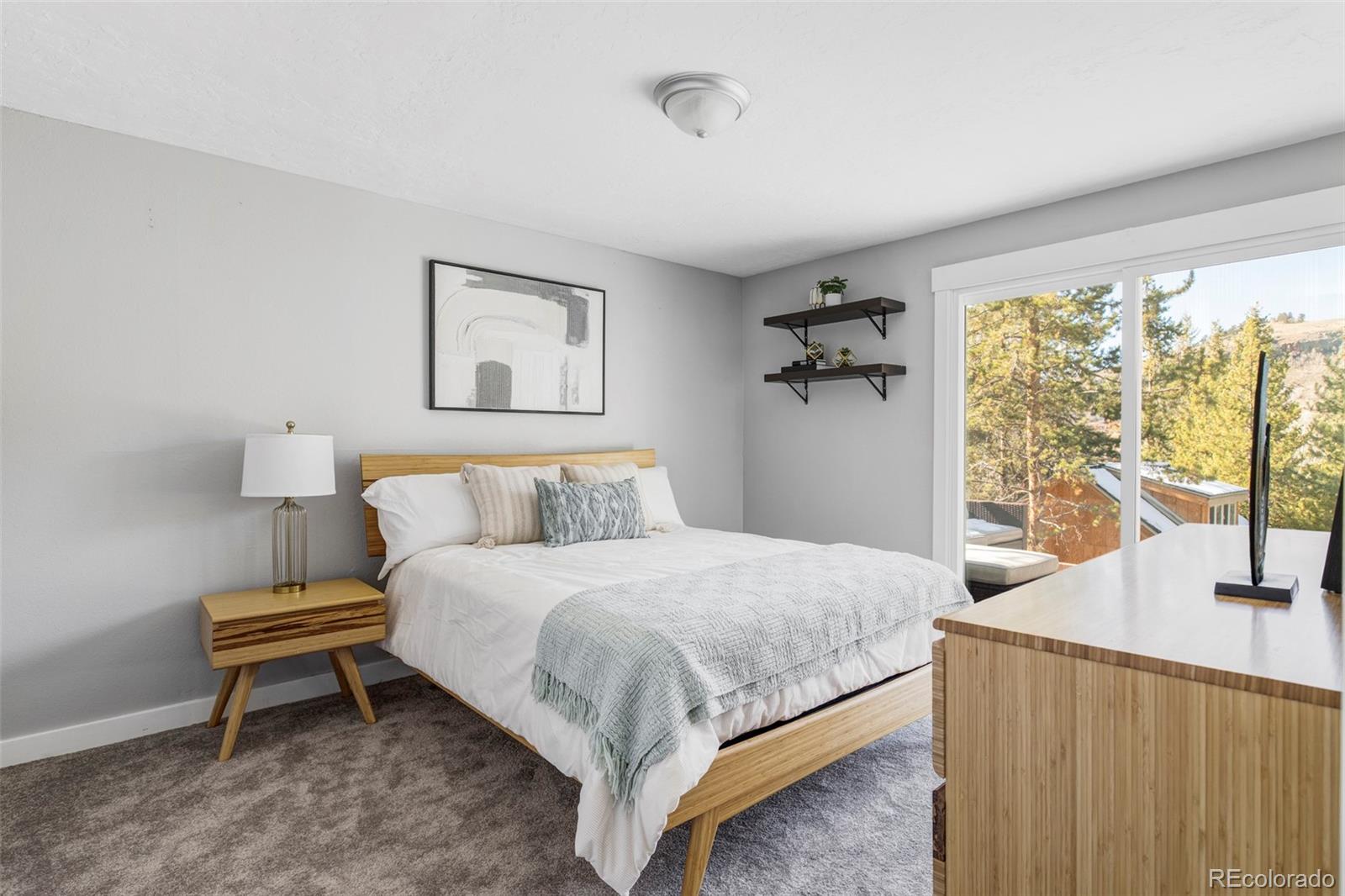 297 Deer Path Road Dillon, CO 80435 - Photo 29 of 49 a bedroom with a bed and a window