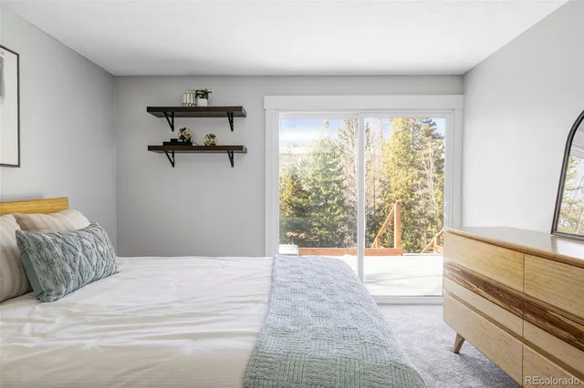 a bedroom with a balcony a bed and a window