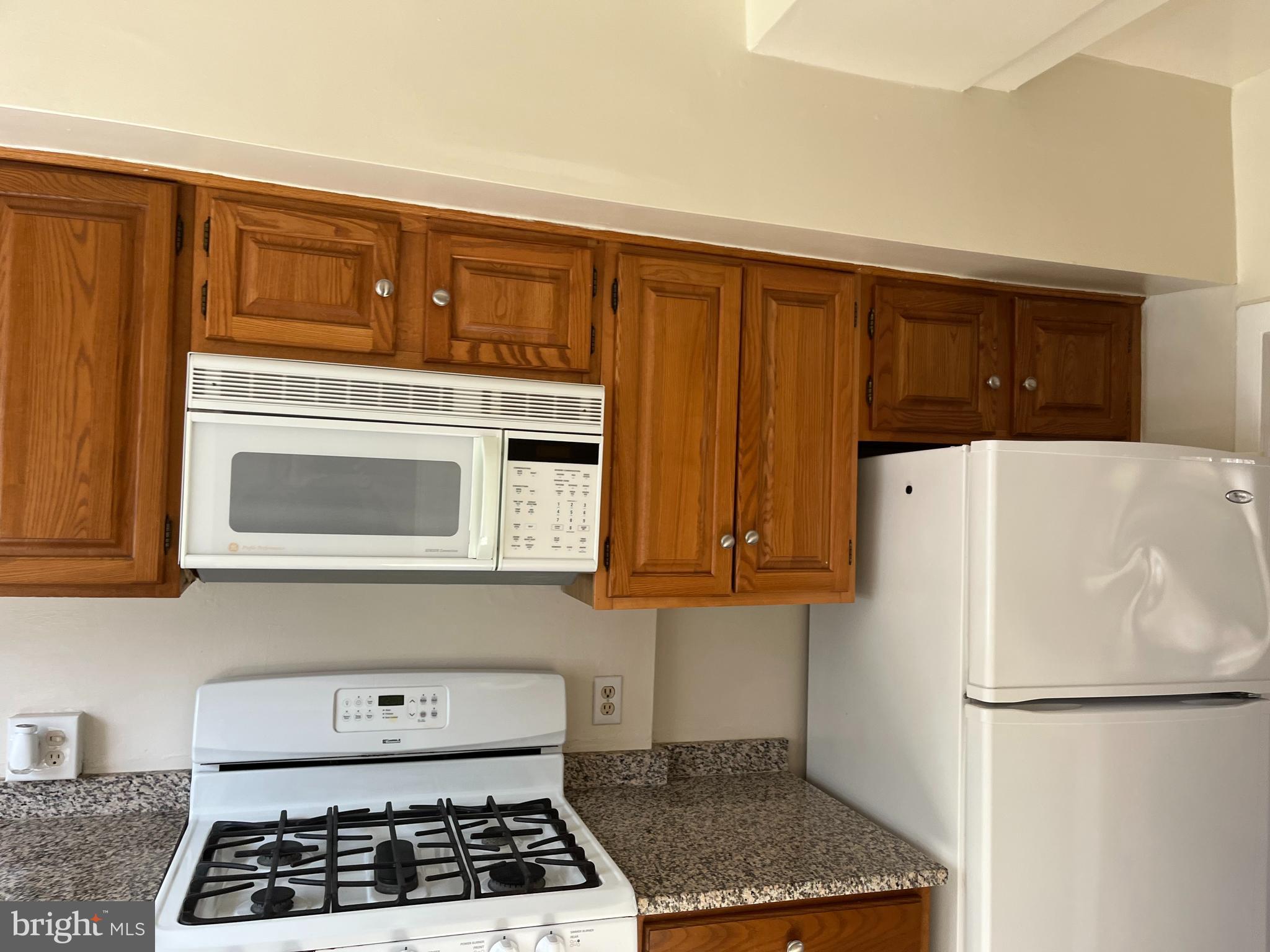 3216 Gunston Road Alexandria, VA 22302 - Photo 3 of 15 a kitchen with a refrigerator and a stove top oven