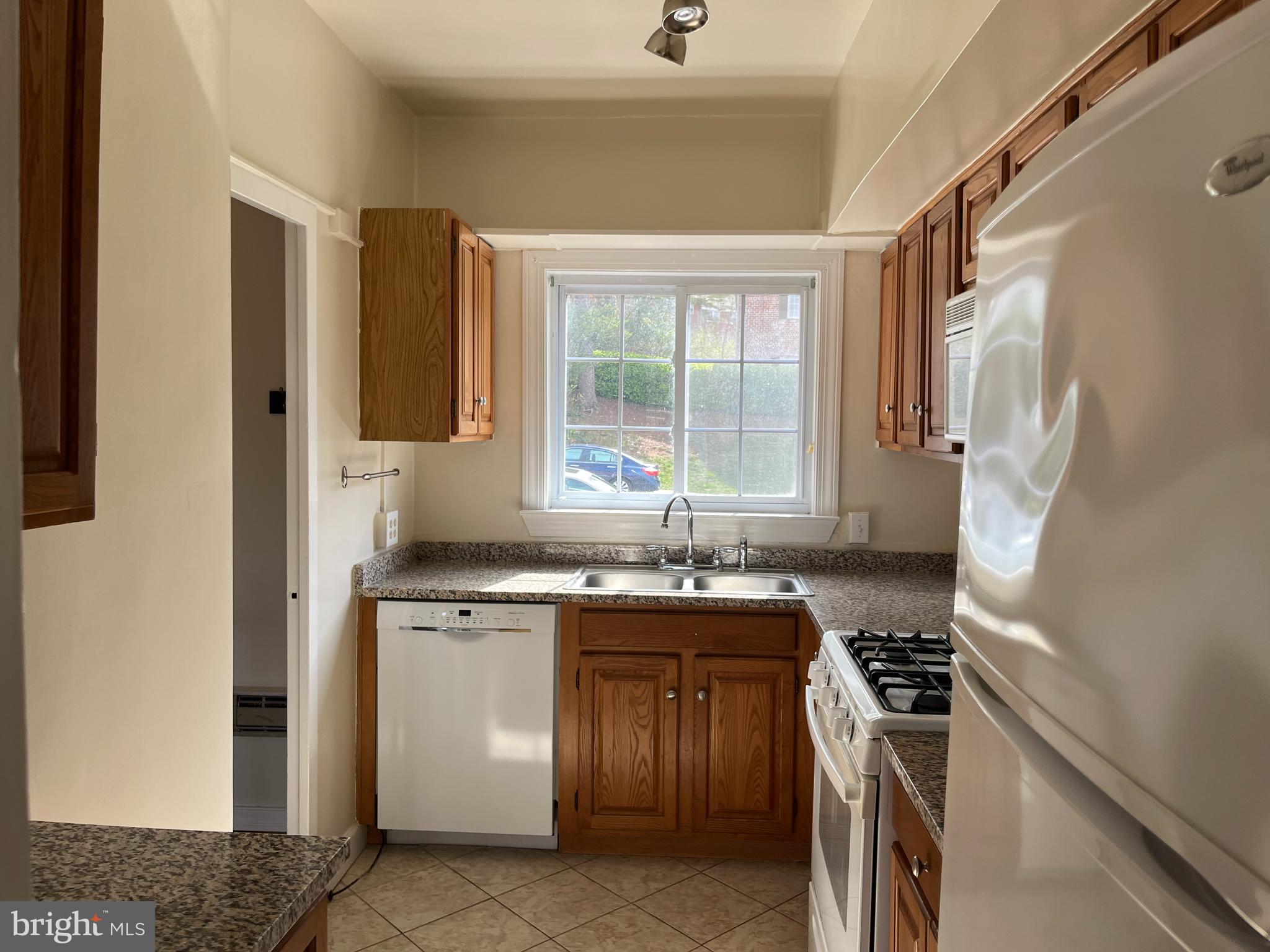 3216 Gunston Road Alexandria, VA 22302 - Photo 4 of 15 a kitchen with a sink stove and cabinets