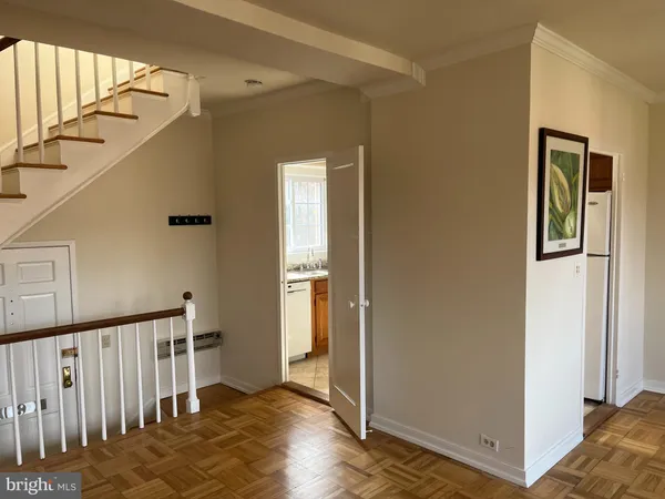 a view of a hallway with entryway with wooden floor