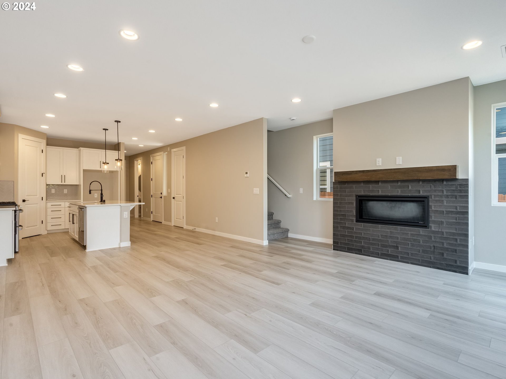 834 Northwest 178th Street Ridgefield, WA 98642 - Photo 15 of 36 a view of a kitchen with a sink and a fireplace