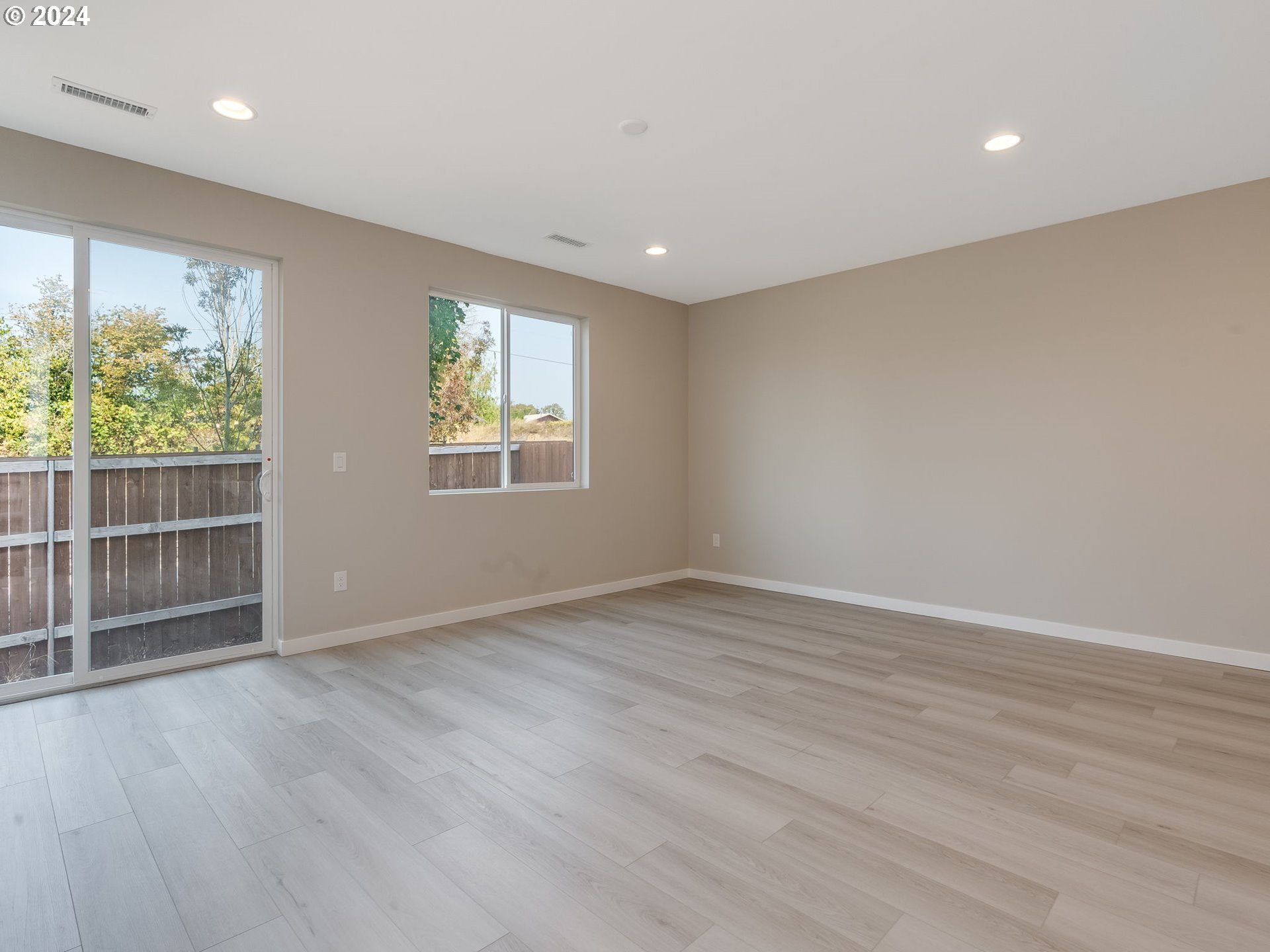 834 Northwest 178th Street Ridgefield, WA 98642 - Photo 17 of 36 an empty room with wooden floor and windows