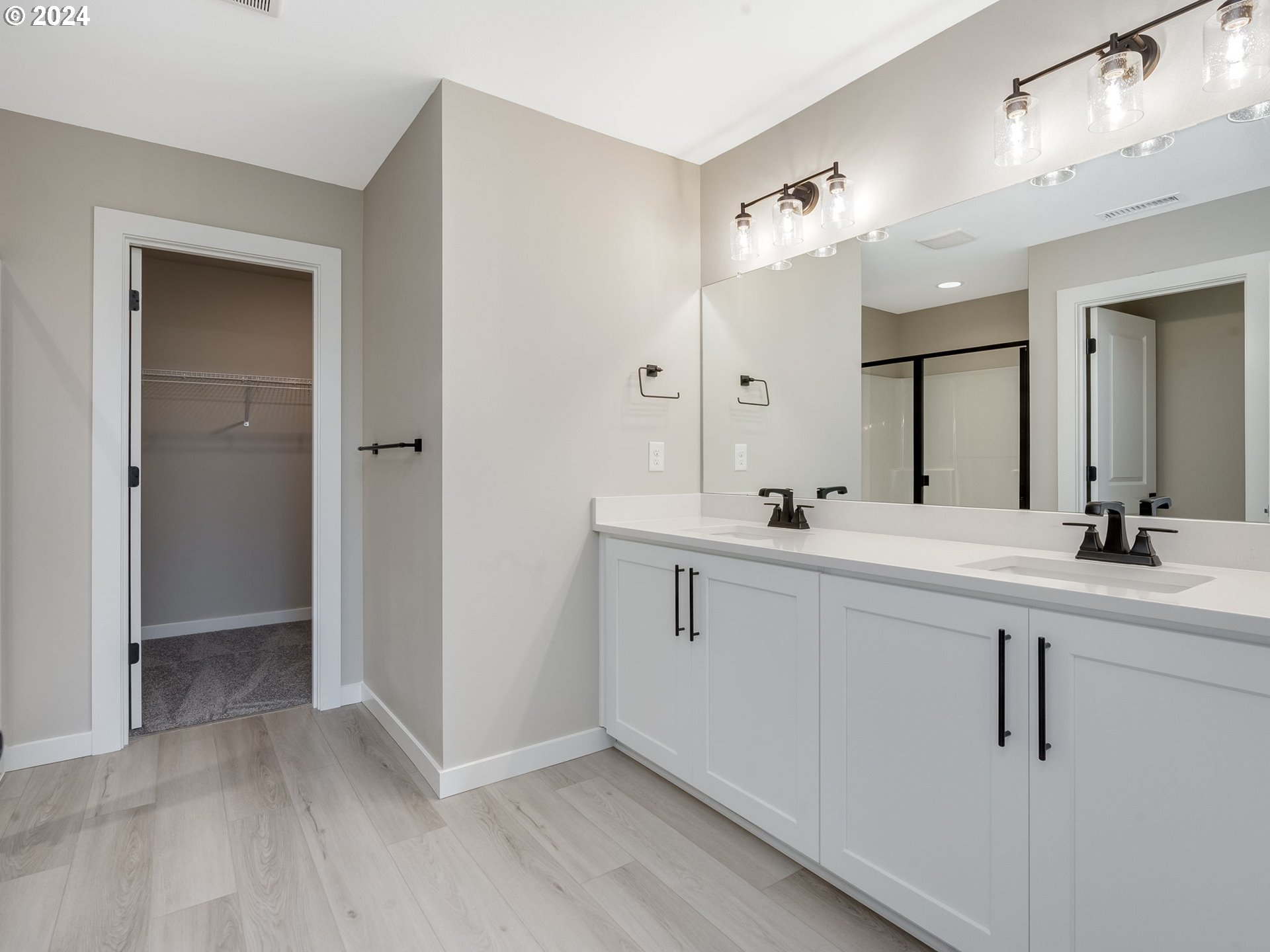 834 Northwest 178th Street Ridgefield, WA 98642 - Photo 34 of 36 a spacious bathroom with a double vanity sink and mirror