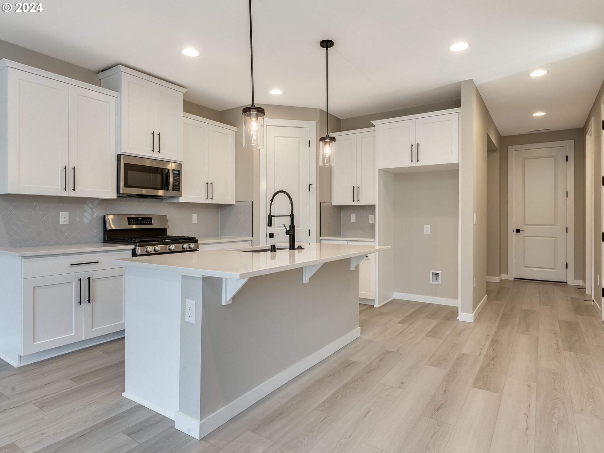 834 Northwest 178th Street Ridgefield, WA 98642 - Photo 8 of 36 a kitchen with stainless steel appliances granite countertop a refrigerator a stove a sink and a microwave