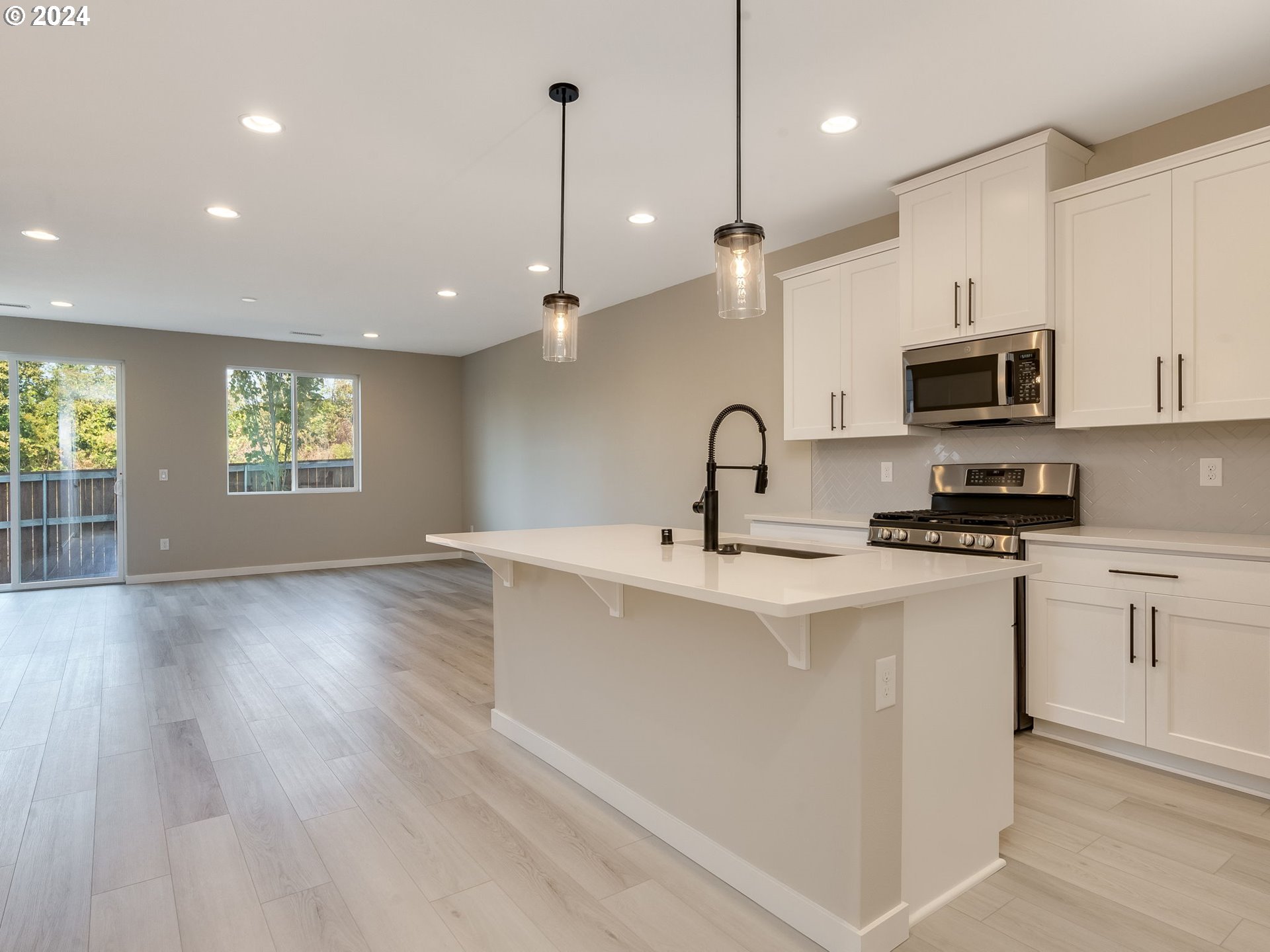 834 Northwest 178th Street Ridgefield, WA 98642 - Photo 10 of 36 a kitchen with stainless steel appliances granite countertop a stove a sink a refrigerator and a microwave
