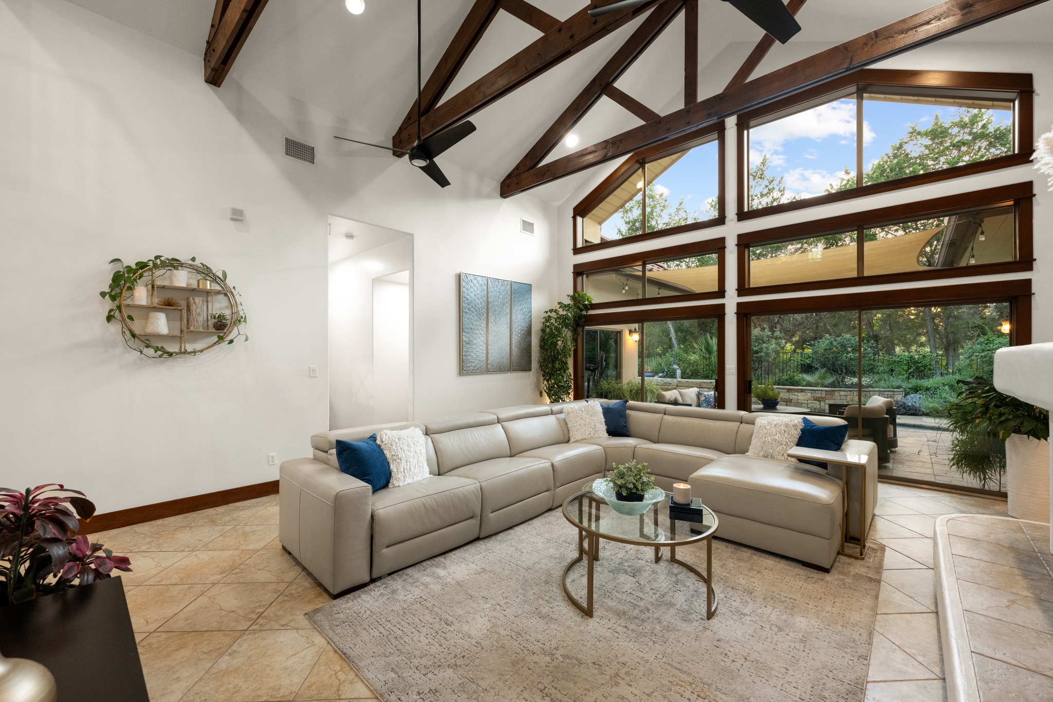 407 Hurst Creek Road Lakeway, TX 78734 - Photo 5 of 40 This oversized showstopping Great Room has wood beam vaulted ceilings and a wall of windows leading to the pool and backyard.
