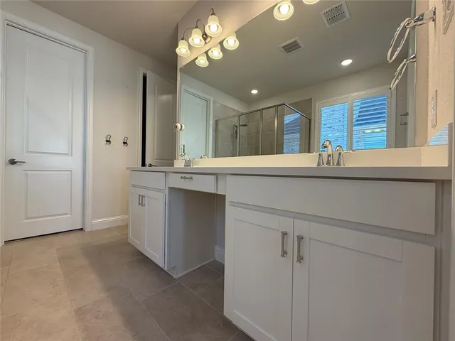 a view of a kitchen with a sink and chandelier