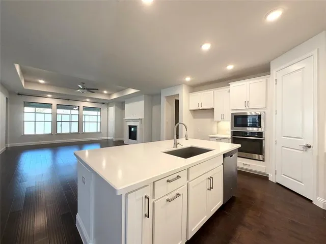 a kitchen with a stove a sink and a refrigerator