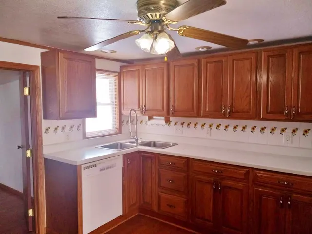 a kitchen with granite countertop cabinets and black appliances