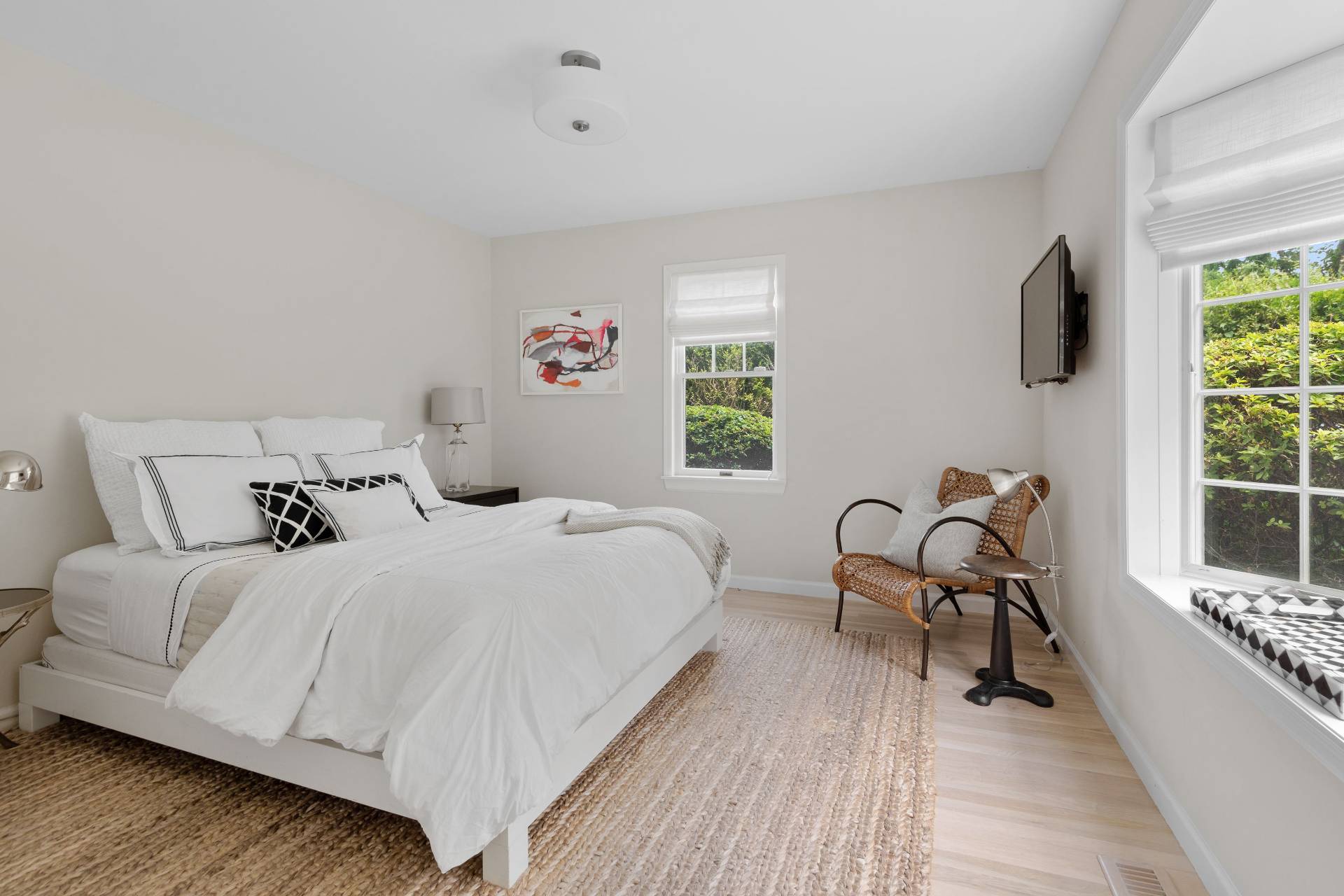 124 Ocean Road Bridgehampton, NY 11932 - Photo 17 of 27 a bedroom with a bed a table and a large window