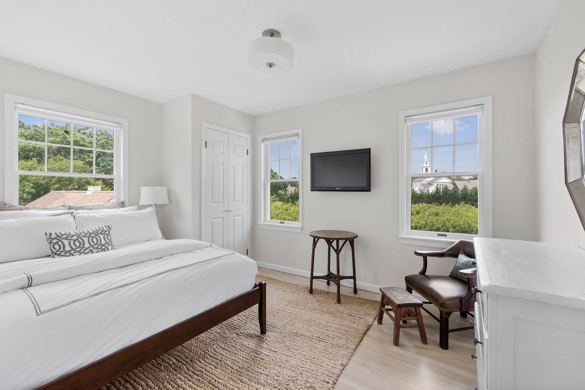 124 Ocean Road Bridgehampton, NY 11932 - Photo 18 of 27 a bedroom with a bed and a chair