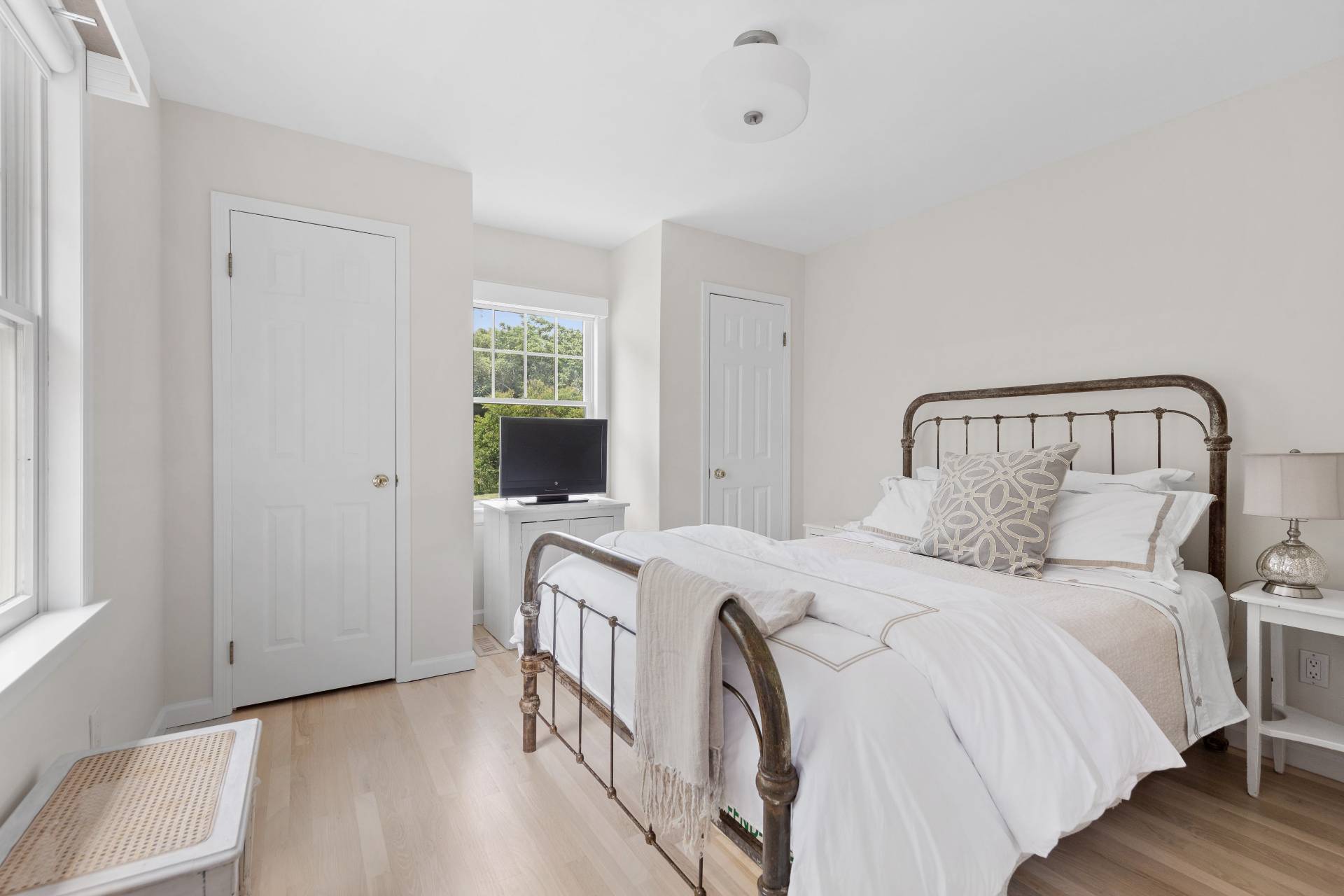 124 Ocean Road Bridgehampton, NY 11932 - Photo 20 of 27 a bedroom with a bed and a flat screen tv
